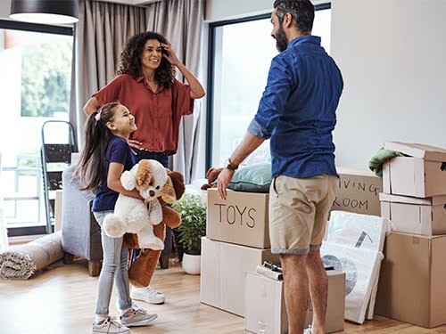 Family moving boxes into new home.