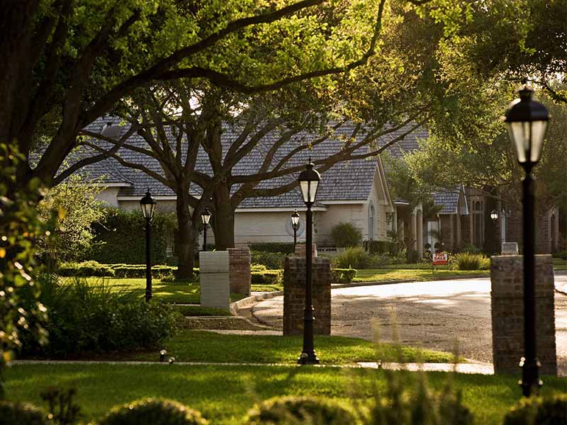 quiet, high-end neighborhood with traditional street lamps lining the road.